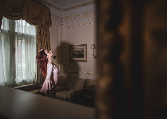 Mistress Adreena in a luxurious room.