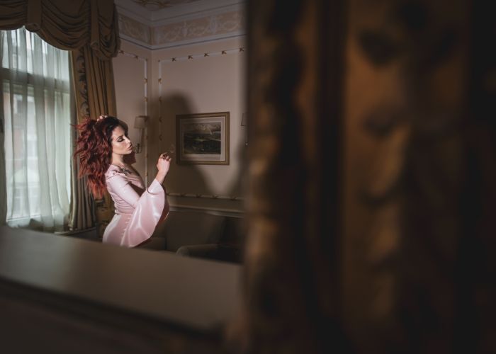 Mistress Adreena in a luxurious room.
