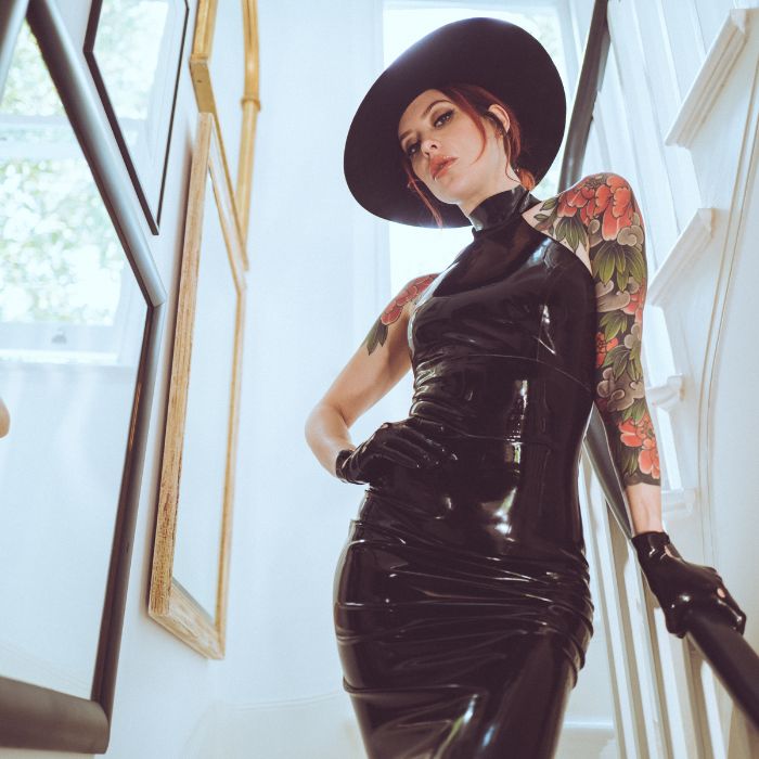 Mistress Adreena in latex, looking down at you.