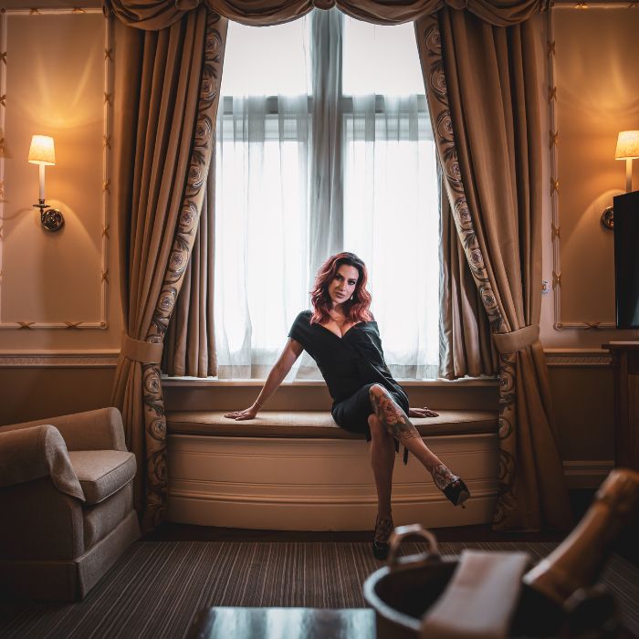 Mistress Adreena sitting with crossed legs.